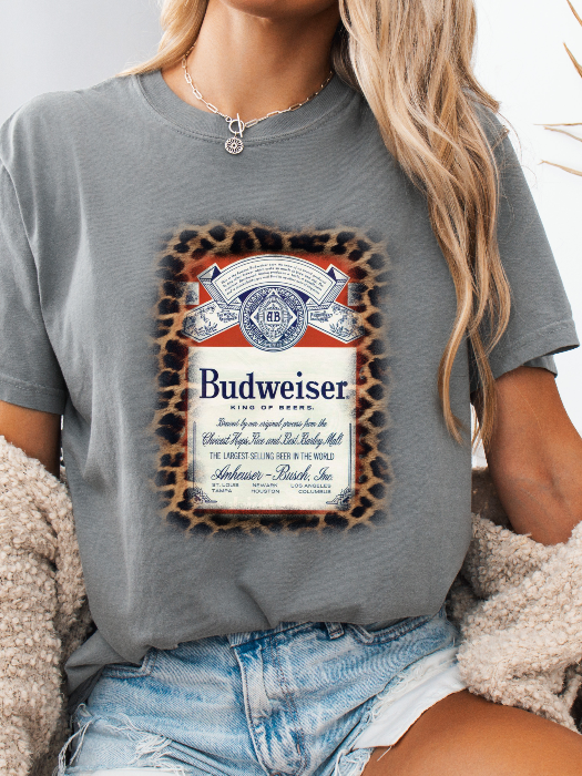 King of Beers Graphic Tee made from soft 100% cotton featuring a vintage-inspired beer graphic, perfect for tailgates, BBQs, brewery visits, country concerts, and casual everyday style. Color Grey