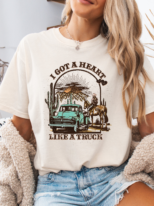 Heart Like A Truck Graphic Tee featuring an exclusive Willow Boutique country-inspired design on soft 100% cotton, perfect for country concerts, rodeos, Nashville trips, and everyday western style. Tshirt in Ivory