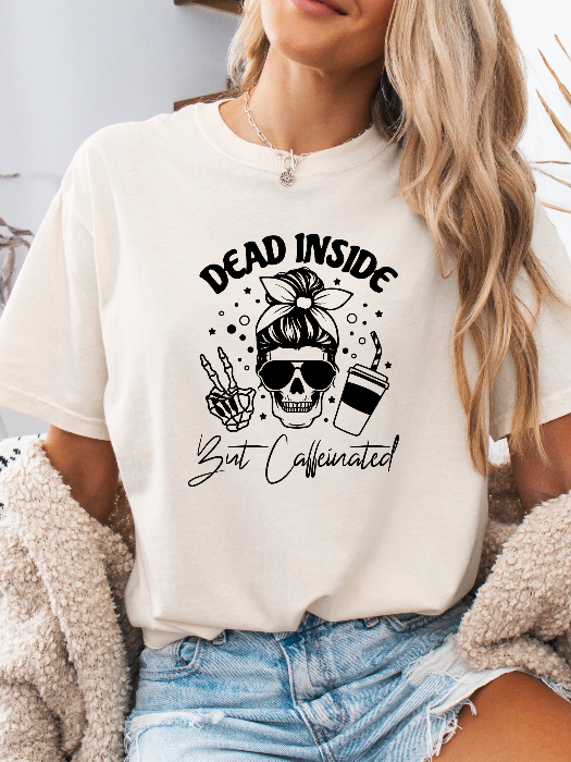 Dead Inside But Caffeinated graphic available as a tee, crewneck, or sweatshirt featuring a fun coffee-inspired design on soft cotton-blend fabric, perfect for Halloween, spooky season, and everyday fall outfits. Tshirt in White
