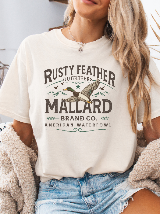 Rusty Feathered Mallard Graphic Tee printed on premium Comfort Colors 100% cotton featuring a detailed vintage-inspired mallard duck design, perfect for outdoor adventures, lake weekends, and casual country style. Tshirt in Ivory