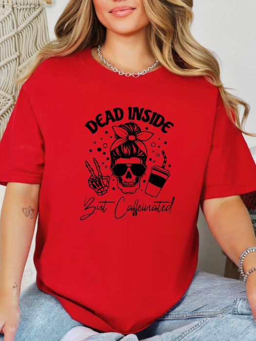 Dead Inside But Caffeinated graphic available as a tee, crewneck, or sweatshirt featuring a fun coffee-inspired design on soft cotton-blend fabric, perfect for Halloween, spooky season, and everyday fall outfits. TShirt in Red