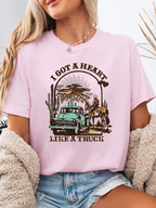 Heart Like A Truck Graphic Tee featuring an exclusive Willow Boutique country-inspired design on soft 100% cotton, perfect for country concerts, rodeos, Nashville trips, and everyday western style. Tshirt in Light Pink