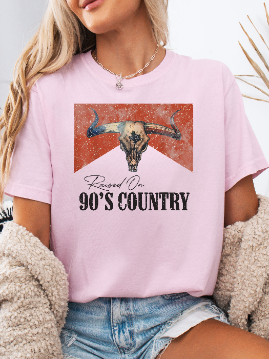 Raised On 90's Country Graphic Tee printed on premium Comfort Colors cotton, featuring an exclusive Willow Boutique design perfect for country concerts, rodeos, and everyday western-inspired style. Tshirt in light pink