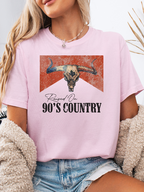 Raised On 90's Country Graphic Tee printed on premium Comfort Colors cotton, featuring an exclusive Willow Boutique design perfect for country concerts, rodeos, and everyday western-inspired style. Tshirt in light pink