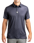 Men’s Big Blind golf polo by Pins & Aces featuring a subtle dark gray and black geometric pattern with short sleeves, collared neckline, and athletic fit.
