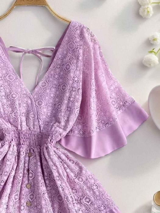 Hope Ruffle Hem Lace Mini Dress featuring delicate lace detailing, a flowy silhouette, feminine ruffle hem, and adjustable tie-back design, perfect for weddings, bridal showers, vacations, and spring or summer occasions. Color Lavender
