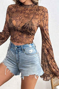 Saylor Mock Neck Flared Sleeve Top featuring sheer mesh long sleeves, an elegant mock neckline, flattering stretch fit, and dramatic flared sleeve cuffs for a chic boutique look.