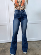 Keep Up Flare Dark Wash Jeans featuring Willow Boutique's exclusive V-Cross waistband, high-rise fit, mega stretch denim, frayed hem, and dramatic flare leg for a flattering boutique look.