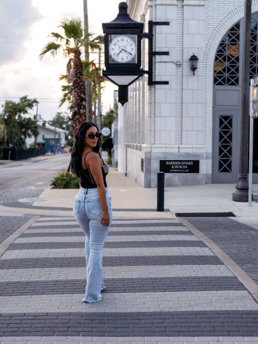 Keep Up Flare Acid Wash Jeans featuring Willow Boutique's exclusive V-Cross waistband, high-rise fit, mega stretch denim, frayed hem, and dramatic flare leg for a flattering boutique look.