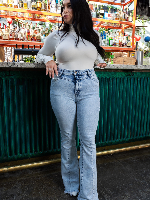 Keep Up Flare Acid Wash Jeans featuring Willow Boutique's exclusive V-Cross waistband, high-rise fit, mega stretch denim, frayed hem, and dramatic flare leg for a flattering boutique look.