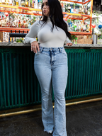 Keep Up Flare Acid Wash Jeans featuring Willow Boutique's exclusive V-Cross waistband, high-rise fit, mega stretch denim, frayed hem, and dramatic flare leg for a flattering boutique look.