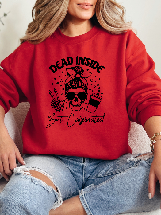 Dead Inside But Caffeinated graphic available as a tee, crewneck, or sweatshirt featuring a fun coffee-inspired design on soft cotton-blend fabric, perfect for Halloween, spooky season, and everyday fall outfits. Crewneck in Red