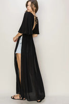 Woman wearing HYFVE Tie Back Maxi Split Cover Up Dress with plunging neckline and side slit maxi skirt