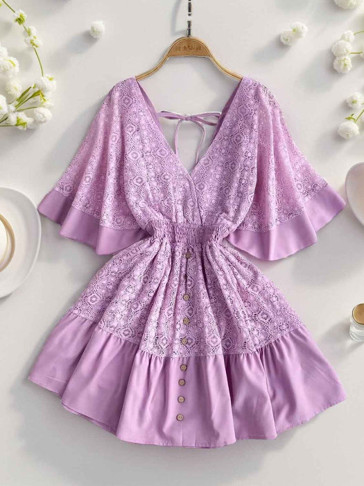 Hope Ruffle Hem Lace Mini Dress featuring delicate lace detailing, a flowy silhouette, feminine ruffle hem, and adjustable tie-back design, perfect for weddings, bridal showers, vacations, and spring or summer occasions. Color Lavender