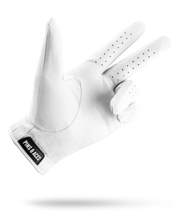 Pins & Aces Premium Tour Ghost White unisex golf glove made from 100% premium AAA Cabretta leather with moisture-wicking wrist lining and men’s standard sizing.
