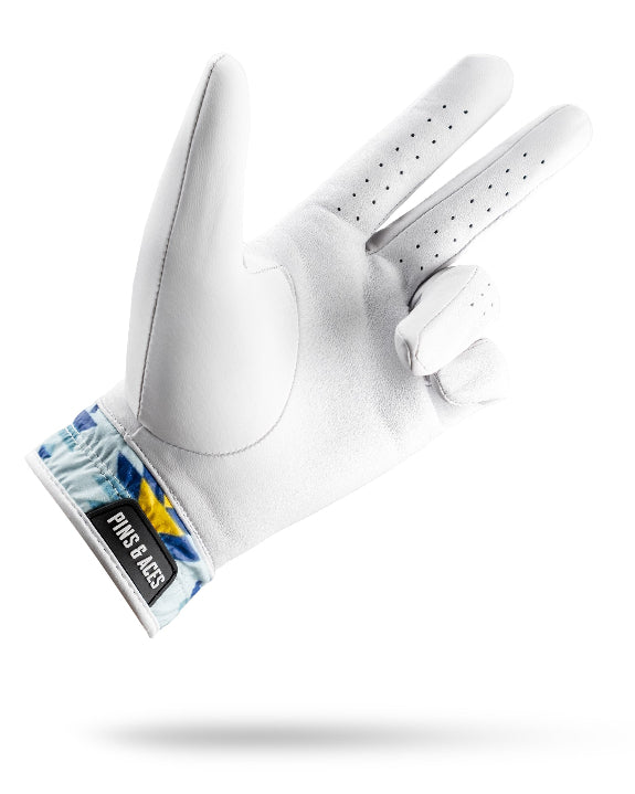 White Pins & Aces Southwest Sunset Premium Tour golf glove made from Cabretta leather with perforated fingers and a colorful Southwest-inspired wrist design.
