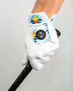 White Pins & Aces Southwest Sunset Premium Tour golf glove made from Cabretta leather with perforated fingers and a colorful Southwest-inspired wrist design.
