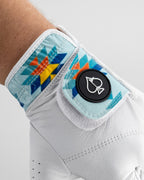 White Pins & Aces Southwest Sunset Premium Tour golf glove made from Cabretta leather with perforated fingers and a colorful Southwest-inspired wrist design.