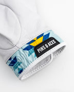 White Pins & Aces Southwest Sunset Premium Tour golf glove made from Cabretta leather with perforated fingers and a colorful Southwest-inspired wrist design.