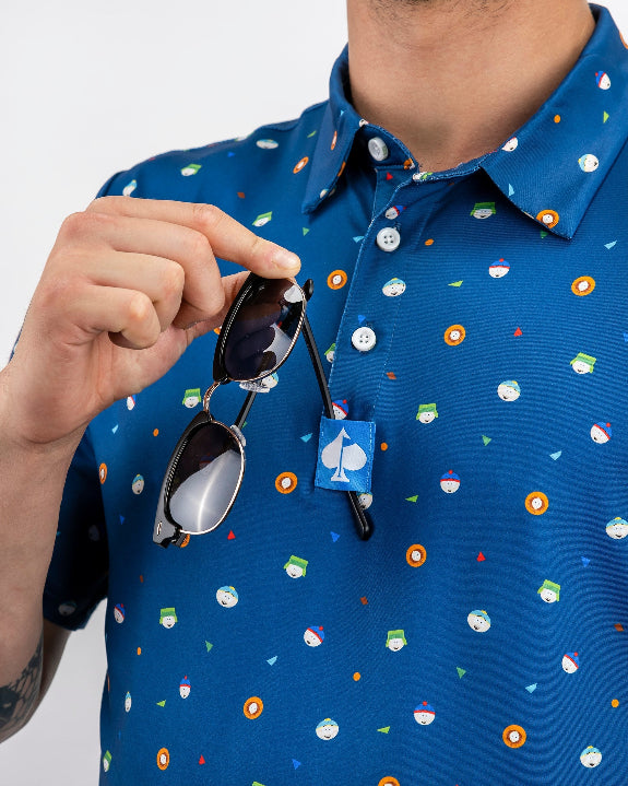 Men’s South Park Classic golf polo by Pins & Aces featuring a blue base with a colorful all-over South Park-themed print, short sleeves, and athletic performance fit.