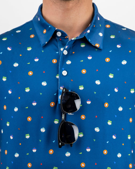 Men’s South Park Classic golf polo by Pins & Aces featuring a blue base with a colorful all-over South Park-themed print, short sleeves, and athletic performance fit.