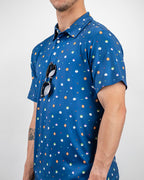 Men’s South Park Classic golf polo by Pins & Aces featuring a blue base with a colorful all-over South Park-themed print, short sleeves, and athletic performance fit.
