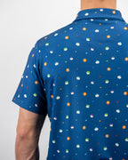 Men’s South Park Classic golf polo by Pins & Aces featuring a blue base with a colorful all-over South Park-themed print, short sleeves, and athletic performance fit.