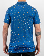 Men’s South Park Classic golf polo by Pins & Aces featuring a blue base with a colorful all-over South Park-themed print, short sleeves, and athletic performance fit.