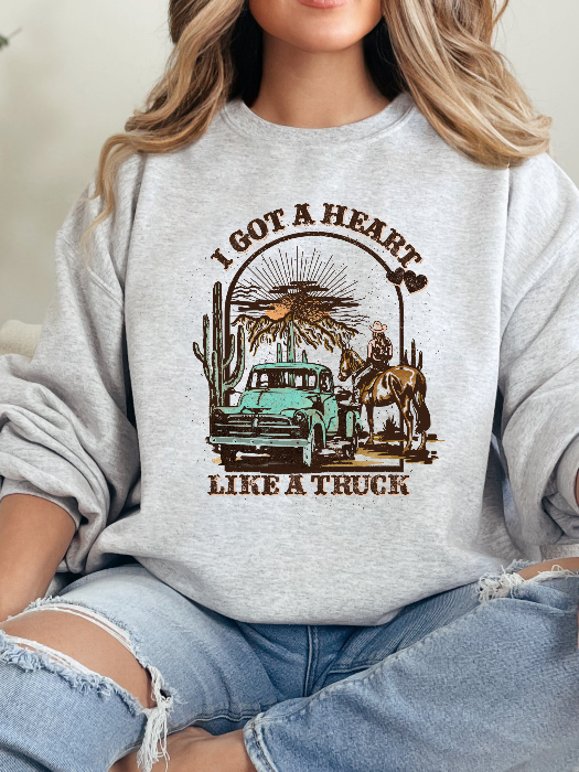 Heart Like A Truck Graphic Tee featuring an exclusive Willow Boutique country-inspired design on soft 100% cotton, perfect for country concerts, rodeos, Nashville trips, and everyday western style. Crewneck in Grey