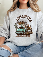 Heart Like A Truck Graphic Tee featuring an exclusive Willow Boutique country-inspired design on soft 100% cotton, perfect for country concerts, rodeos, Nashville trips, and everyday western style. Crewneck in Grey