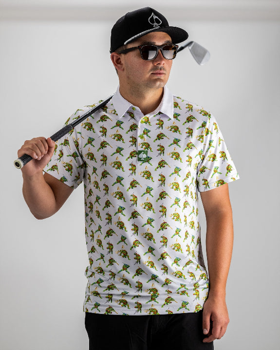 White TMNT Cowabunga Classic 8-Bit golf polo by Pins & Aces featuring an all-over retro pixel-style Teenage Mutant Ninja Turtles character print.