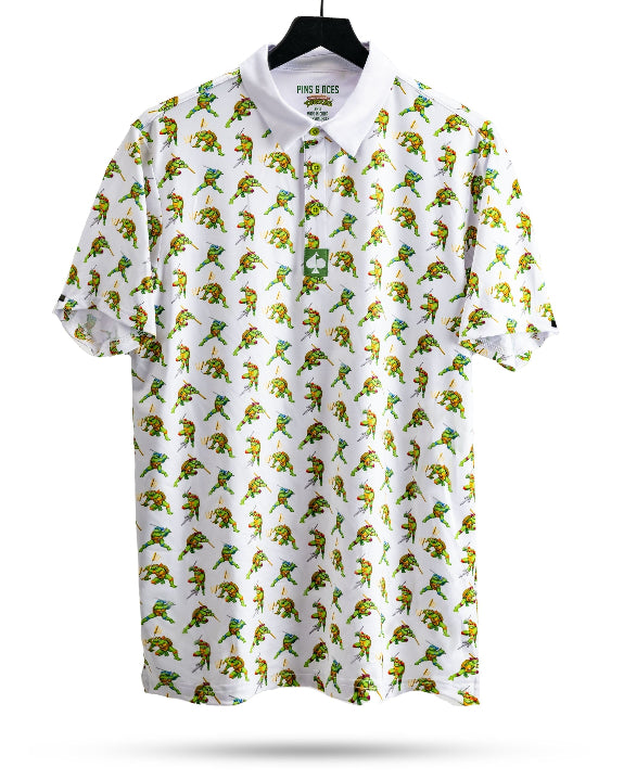 White TMNT Cowabunga Classic 8-Bit golf polo by Pins & Aces featuring an all-over retro pixel-style Teenage Mutant Ninja Turtles character print.