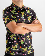 Black TMNT Turtle Flower Power golf polo by Pins & Aces featuring colorful Teenage Mutant Ninja Turtles characters and floral print.
