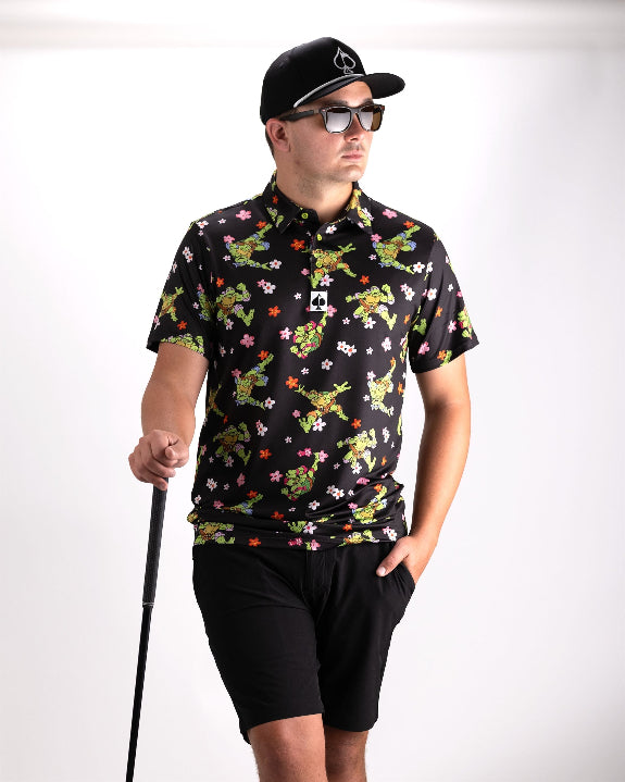 Black TMNT Turtle Flower Power golf polo by Pins & Aces featuring colorful Teenage Mutant Ninja Turtles characters and floral print.