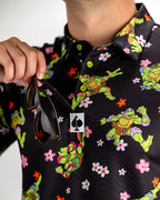 Black TMNT Turtle Flower Power golf polo by Pins & Aces featuring colorful Teenage Mutant Ninja Turtles characters and floral print.