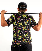 Black TMNT Turtle Flower Power golf polo by Pins & Aces featuring colorful Teenage Mutant Ninja Turtles characters and floral print.
