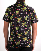 Black TMNT Turtle Flower Power golf polo by Pins & Aces featuring colorful Teenage Mutant Ninja Turtles characters and floral print.