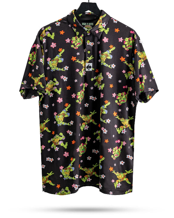 Black TMNT Turtle Flower Power golf polo by Pins & Aces featuring colorful Teenage Mutant Ninja Turtles characters and floral print.