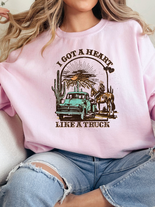Heart Like A Truck Graphic Tee featuring an exclusive Willow Boutique country-inspired design on soft 100% cotton, perfect for country concerts, rodeos, Nashville trips, and everyday western style. Crewneck in Light Pink