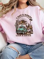 Heart Like A Truck Graphic Tee featuring an exclusive Willow Boutique country-inspired design on soft 100% cotton, perfect for country concerts, rodeos, Nashville trips, and everyday western style. Crewneck in Light Pink