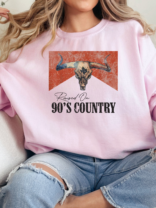 Raised On 90's Country Graphic Tee printed on premium Comfort Colors cotton, featuring an exclusive Willow Boutique design perfect for country concerts, rodeos, and everyday western-inspired style. Crewneck in Light Pink