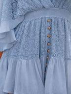 Hope Ruffle Hem Lace Mini Dress featuring delicate lace detailing, a flowy silhouette, feminine ruffle hem, and adjustable tie-back design, perfect for weddings, bridal showers, vacations, and spring or summer occasions. Color Light Blue