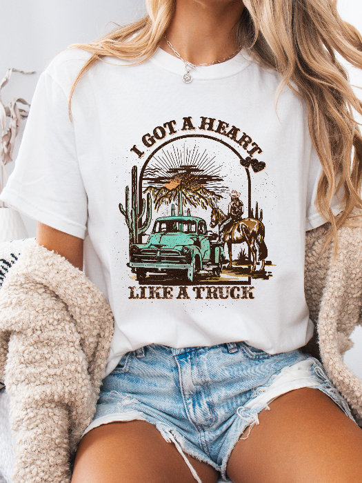 Heart Like A Truck Graphic Tee featuring an exclusive Willow Boutique country-inspired design on soft 100% cotton, perfect for country concerts, rodeos, Nashville trips, and everyday western style. TSHIRT in White