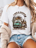 Heart Like A Truck Graphic Tee featuring an exclusive Willow Boutique country-inspired design on soft 100% cotton, perfect for country concerts, rodeos, Nashville trips, and everyday western style. TSHIRT in White