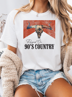 Raised On 90's Country Graphic Tee printed on premium Comfort Colors cotton, featuring an exclusive Willow Boutique design perfect for country concerts, rodeos, and everyday western-inspired style.