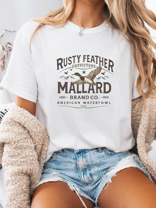 Rusty Feathered Mallard Graphic Tee printed on premium Comfort Colors 100% cotton featuring a detailed vintage-inspired mallard duck design, perfect for outdoor adventures, lake weekends, and casual country style. Tshirt in White