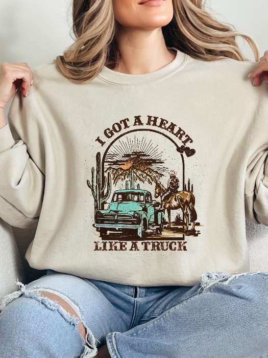 Heart Like A Truck Graphic Tee featuring an exclusive Willow Boutique country-inspired design on soft 100% cotton, perfect for country concerts, rodeos, Nashville trips, and everyday western style. Crewneck in Ivory