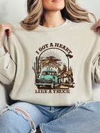 Heart Like A Truck Graphic Tee featuring an exclusive Willow Boutique country-inspired design on soft 100% cotton, perfect for country concerts, rodeos, Nashville trips, and everyday western style. Crewneck in Ivory