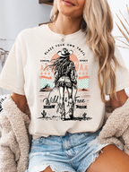 Women’s Blaze Your Own Trail Western graphic tee featuring an original Willow Boutique cowgirl design on a relaxed-fit Comfort Colors® 100% cotton T-shirt in Ivory