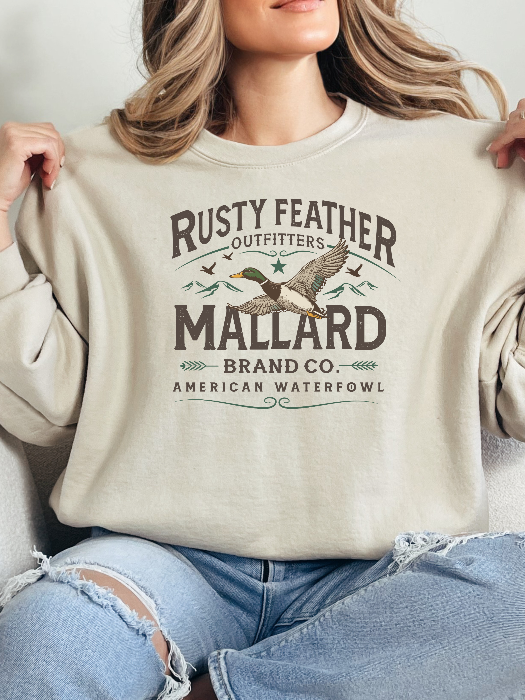 Rusty Feathered Mallard Graphic Tee printed on premium Comfort Colors 100% cotton featuring a detailed vintage-inspired mallard duck design, perfect for outdoor adventures, lake weekends, and casual country style. Crewneck in Ivory